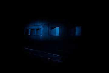 Pale Blue Light Spilling Out of Windows of a Wall onto a Road at Night, Dublin, Ireland