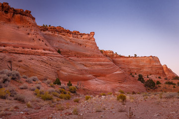 Rocks and Mountains along a trail to Tunnel Slot during sunny day with blue sky in Escalante National Monument,  Grand Staircase trail, Utah, USA