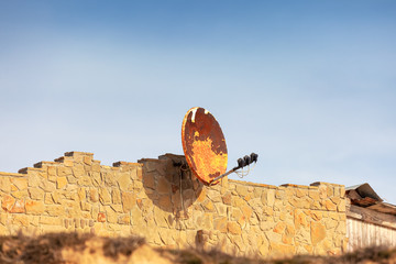 Rusty Abandoned Satellite Dish, damaged connection concept.