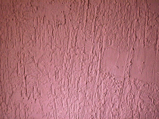Texture. The stucco wall is painted in soft pink color, with flowing long drops.