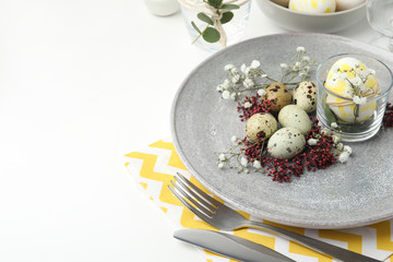 Festive Easter table setting with beautiful floral decor. Space for text