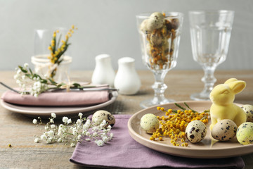 Obraz na płótnie Canvas Festive Easter table setting with beautiful floral decor