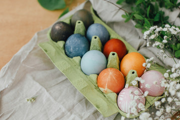 Modern yellow, pink, blue and grey easter eggs painted with organic onion, beets, red cabbage,...