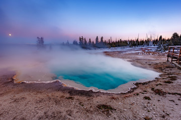 Black Pool at West Thumb Geyser Basin Trail during wonderful colorful sunset, Yellowstone National Park, Wyoming, USA