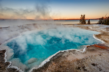 Black Pool at West Thumb Geyser Basin Trail during wonderful colorful sunset, Yellowstone National Park, Wyoming, USA