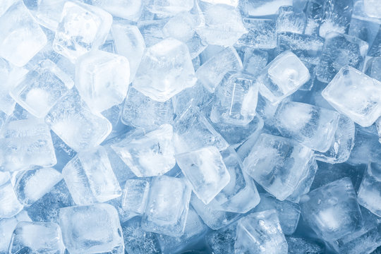 Crystal clear ice cubes as background, top view