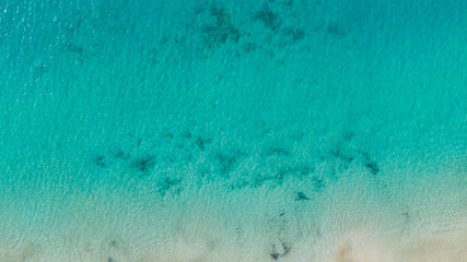 Top View on Coast of Atlantic Ocean, waves on beach aerial view, crystal clear water in Morro Jable Fuerteventura. 