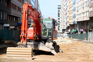 heavy excavator machine at site , road construction in city street
