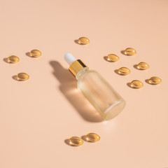 Almond oil in a glass bottle and capsules. Sunlight.