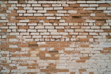Old repaired weathered brick wall for background. 