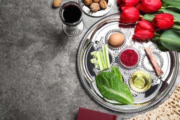 Flat lay composition with Passover Seder plate (keara) on grey table, space for text. Pesah celebration