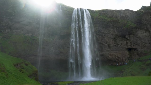 Gljufrabui, Iceland - May 2019: Gljufrabui waterfall with tourists walking, Iceland