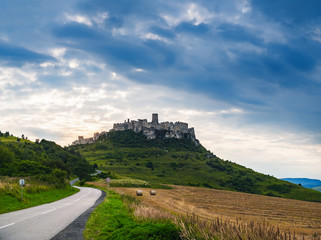 Fototapeta na wymiar Ancient ruins of medieval Spis Castle in Slovakia. Dramatic sunset landscape with Slovak old fortress and fields