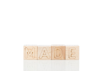 Wooden cubes with word made on a white background