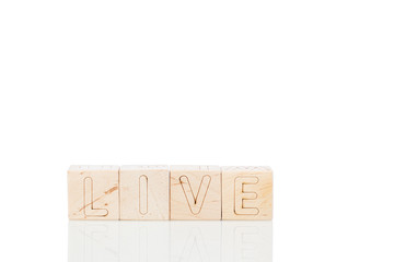 Wooden cubes with word live on a white background