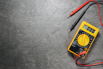 Multimeter on gray flat lay background with copy space.