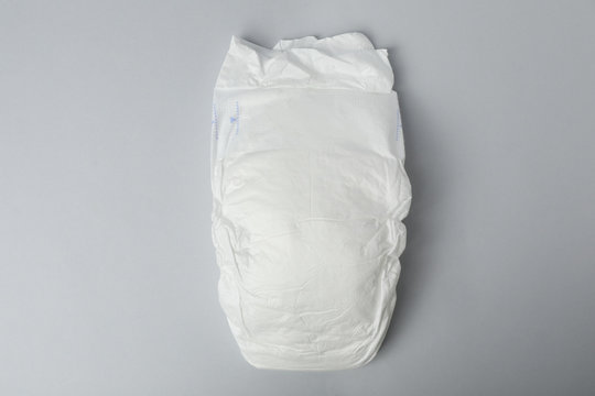 Baby diaper on grey background, top view
