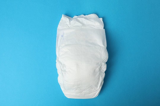 Baby diaper on blue background, top view