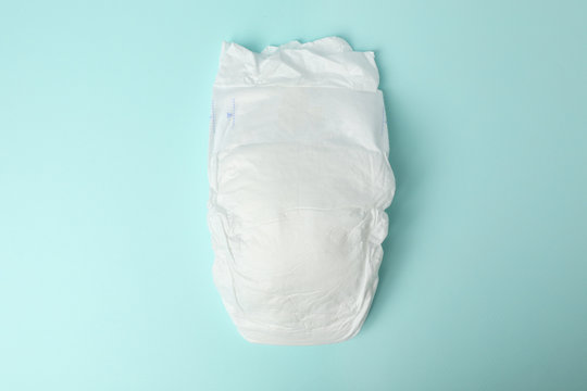 Baby diaper on light blue background, top view