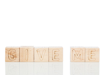 Wooden cubes with word give me on a white background