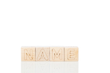 Wooden cubes with word name on a white background