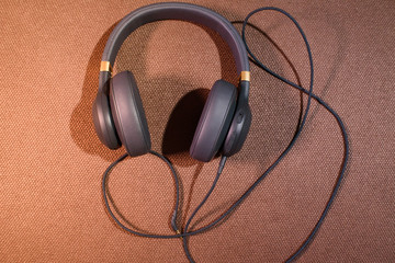 Colored headphones on a colored background. Music concept with copyspace. Colored headphones isolated.