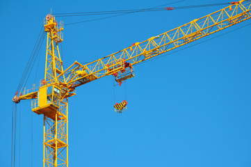 Construction crane on blue sky background