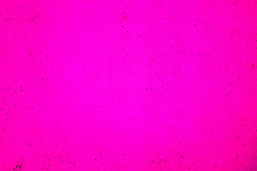 Bright pink background with small black spots.