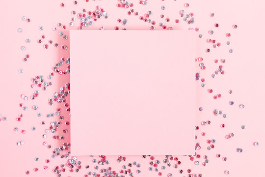 Festive pink background. Empty paper blank. Shining confetti on light pink pastel background. Christmas. Wedding. Birthday. Happy woman's day. Mothers Day. Valentine's Day. Flat lay, top view, copy 
