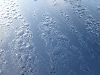 morning dew water drops ona black metallic surface