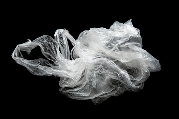 Empty crumpled plastic bag with handles isolated on a black background. Used plastic bag for...