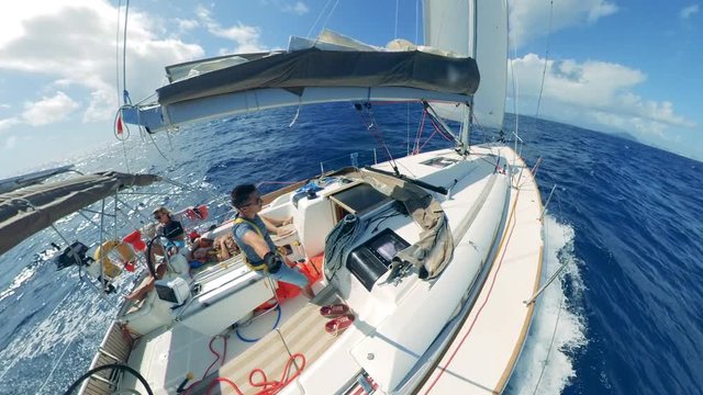 A man onboard of an autopiloted yacht is remote-filming himself. Summer sea holiday vacations.