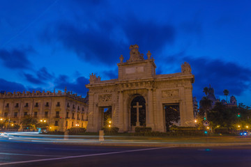 Fototapeta na wymiar Puerta del Mar Triumphal Arch at blue hour with car light trails in Valencia, Spain