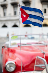 Cuban flag in classic red convertible car