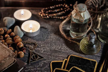 Magic concept. Burning candles, tincture bottles and fortune-telling cards
