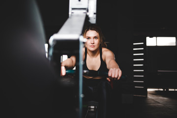Woman trains on a rowing machine