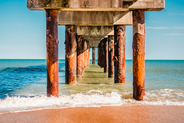 Looking off to the Ocean Between Posts of Pier