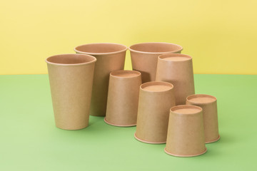 Eco-friendly disposable tableware in yellow and green background.