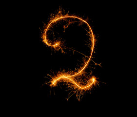 number two written with a sparkler on a black background