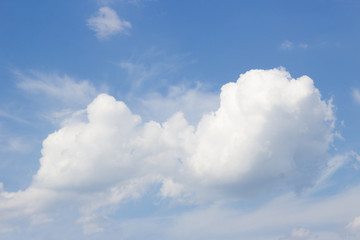 White curly clouds on a blue sky