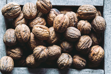 Walnuts with and without shells (filling the picture). Background of fresh walnuts.