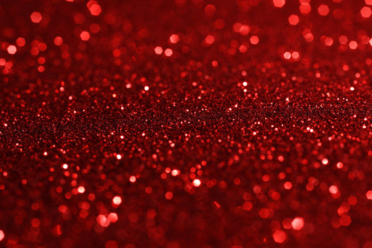 Abstract dark red background with sparkling bokeh.Glitter paper backdrop.