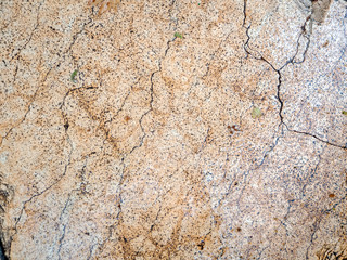 Old beige marble slab whole in cracks. Marble wet from the rain. Stone background.