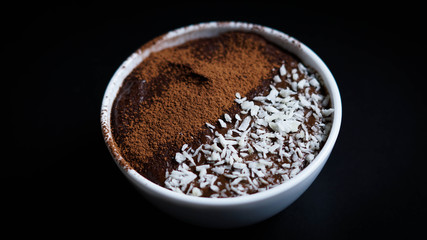 Avocado chocolate dessert with coconut and cocoa powder