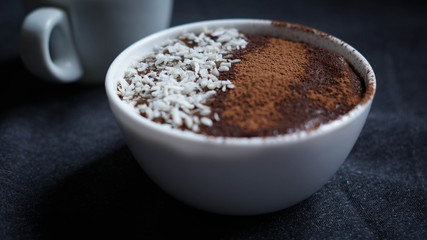Avocado chocolate dessert with coconut and cocoa powder