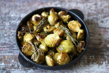 Baked Brussels sprouts with rosemary and spices. Frying pan with baked brussels sprouts.