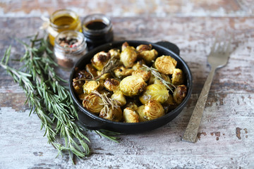 Baked Brussels sprouts with rosemary and spices. Frying pan with baked brussels sprouts.