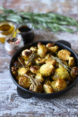 Baked Brussels sprouts with rosemary and spices. Frying pan with baked brussels sprouts.