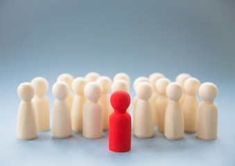 A leader or manager standing out from a crowd of co workers or team mates whilst inspiring them to...