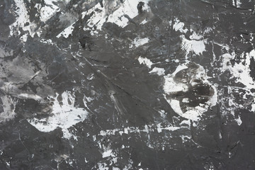 Texture of white putty on a gray surface.